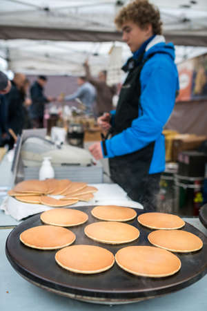Bergen, Norway -  October 2017 :  Men preparing delicious pancakes on the street food marketのeditorial素材