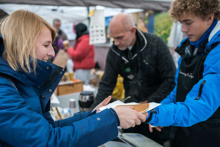 Bergen, Norway -  October 2017 :  Woman buying delicious pancakes on the street food marketのeditorial素材