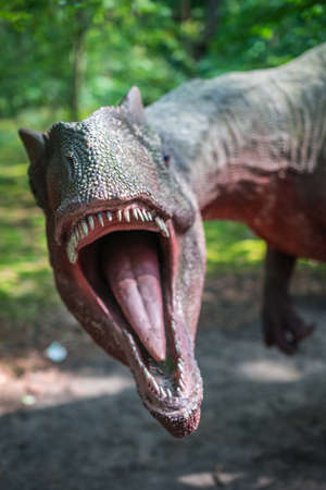 Solec Kujawski, Poland -  August 2017 :  Life sized Allosaurus dinosaur statue in a forestのeditorial素材