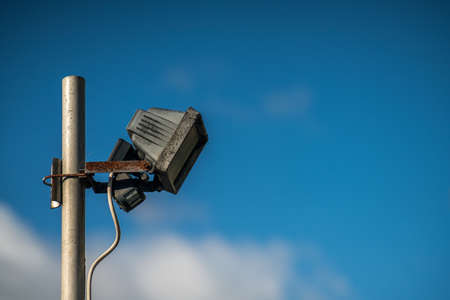 Automatic safety light attached to the metal pole with blue sky backgroundの写真素材