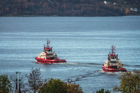 Bergen, Norway -  October 2017 : Two small towing boats leaving Bergen harbour, Norwayのeditorial素材