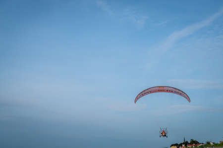 Sarbinowo, Poland -  August 2017 : Paraglider flying with a paramotor over the beach before sunsetのeditorial素材