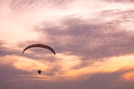 Sarbinowo, Poland -  August 2017 : Paraglider flying with a paramotor during beautiful sunsetのeditorial素材