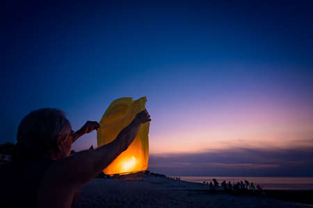 Sarbinowo, Poland -  August 2017 :  People setting off chinese lantern on the beach at sunsetのeditorial素材