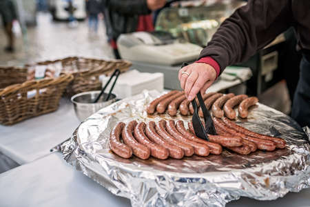 Man preparing hot dogs on the street food market in Bergen, Norwayの写真素材