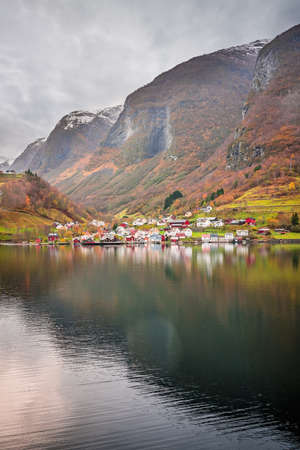 Small homes on the shore of a fjord photographed from a Fjords sightseeing cruise boat in autumn, Norwayの写真素材
