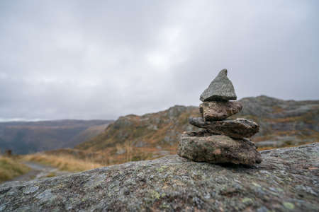 Zen balanced small pile of stacked stones on a walking path starting on top of Mount Ulriken in Bergen, Norwayの写真素材