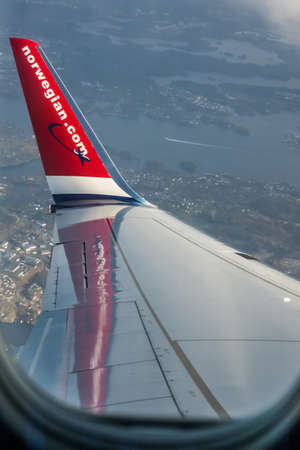 Bergen, Norway -  October 2017 :  Norwegian plane winglet seen from the inside with the Bergen town below, Norwayのeditorial素材