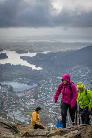Bergen, Norway -  October 2017 :  Group of trekkers arriving at the top of mount Ulriken in Bergen on a rainy and stormy day, Norwayのeditorial素材