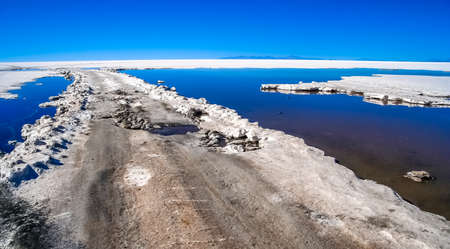 Remote empty road through the Salar de Uyuni in Boliviaの写真素材