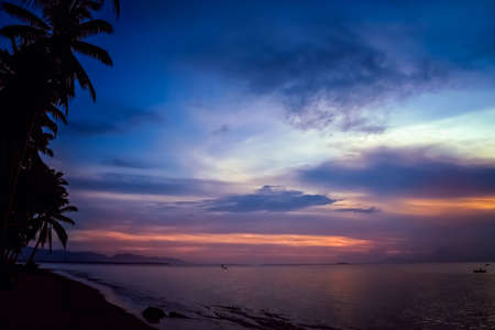 Sunset over the ocean as seen from the beach in Bali, Indonesia, Asiaの写真素材