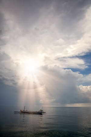 Small fisherman boat on the calm sea on the northern coast of Bali Island, Indonesia, Asiaの写真素材