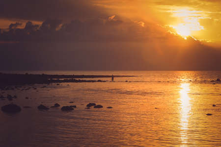 Sunset over the ocean as seen from the beach in Flores, East Nusa Tenggara, Indonesia, Asia