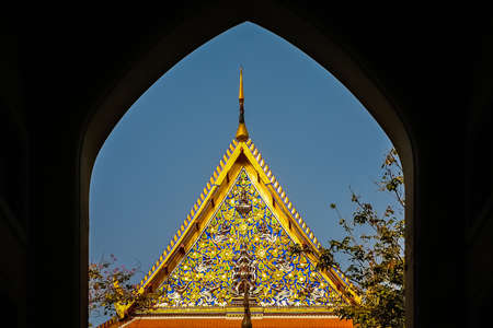 Ornate golden triangular roof of a Buddhist temple in Bangkok, Thailand, Asiaの写真素材