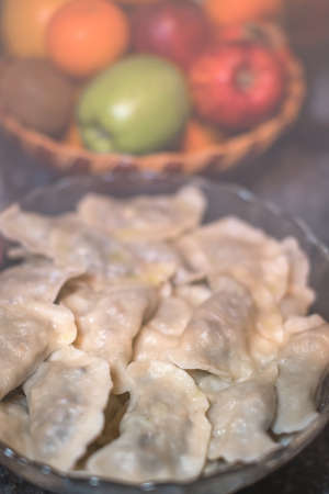 Traditonal Polish food called pierogi in a glass bowl ready to be servedの写真素材
