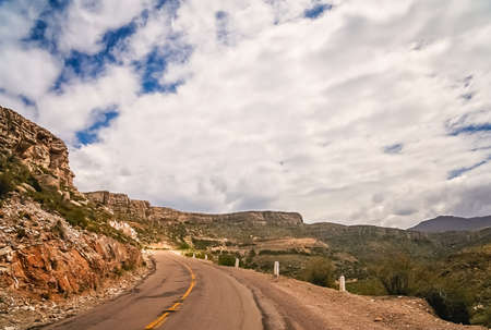 Empty road through dry mountain landscape in the northern part of Argentinaの写真素材