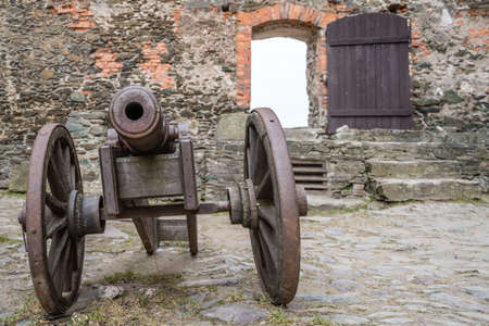 Old brass cannon in the courtyard of the ruins of the medieval Bolkow Castle in Lower Silesia, Polandの写真素材
