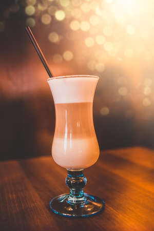 Coffee latte in tall glass served in a coffee barの写真素材