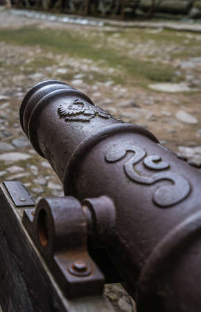 Barrel of an old cannon in the courtyard of the ruins of the medieval Bolkow Castle in Lower Silesia, Polandの写真素材