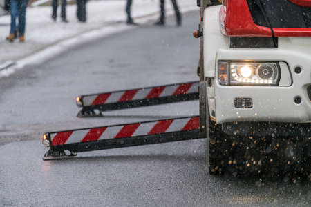 Firefighter sitting in control chair operating an extendable crane arm with his colleagues in it...