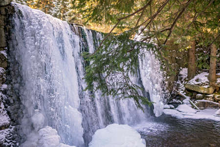 Wild Waterfall, known as Dziki Wodospad, in beautiful scenery of Karkonosze Mountains in Karpacz, Poland, photographed in winterの写真素材