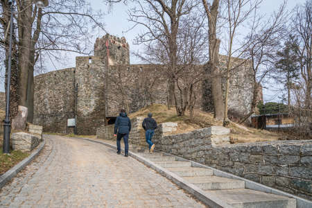 Bolkow, Poland -  February 2018 : Tourists walking to the entrance gate of the ruins of the medieval Bolkow Castle in Lower Silesiaのeditorial素材