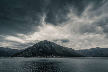 Dramatic cloudy landscape of a mountain on the coast of Bay of Kotor in Montenegro