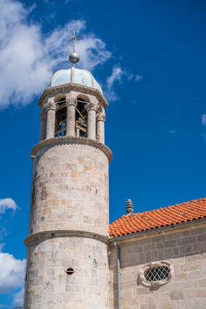 The bell tower of the basilica of Our Lady of the Rocks in Kotor Bay, Perast, Montenegro.の写真素材