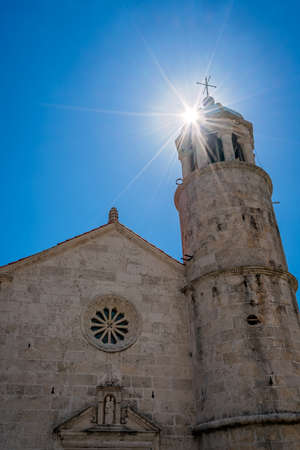 The front facade and bell tower of the basilica of Our Lady of the Rocks in Kotor Bay, Perast, Montenegroの写真素材