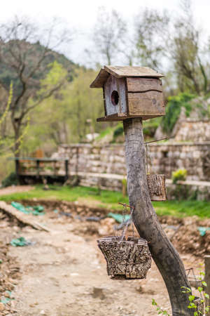Small wooden bird feeder on a farm in Montenegroの写真素材