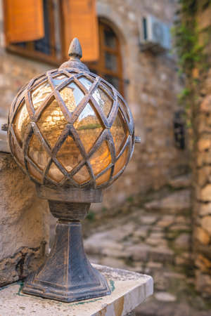 Close up of an old glass and brass street lamp in the Old Town in Ulcinj, Montenegroの写真素材