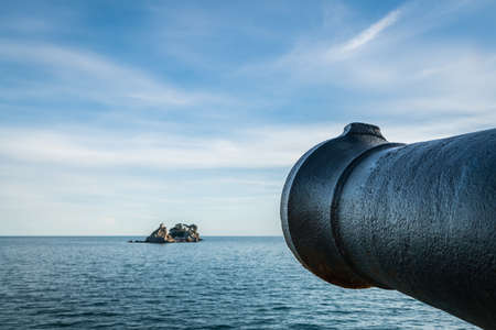 Medieval cannon gun directed on the old Monastery,  walls of the old Petrovac old town fortress, Montenegroの写真素材
