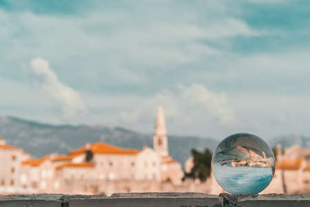 Popular summer resort town Budva on the Adriatic coast in Montenegro reflected in a transparent...