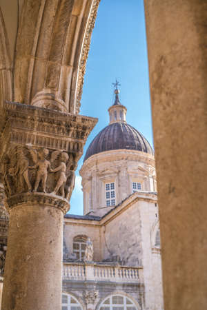 Imposing Church tower dome and close up of the arched roof supporting columns with carved figures, Dubrovnik Old Town, Croatiaの写真素材