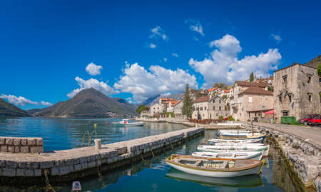 Anchored boats on the shore in the beautiful Perast town in the Kotor Bay, Montenegro