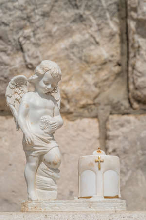 Tiny white angel boy figure sculpture with wings, Dubrovnikの写真素材