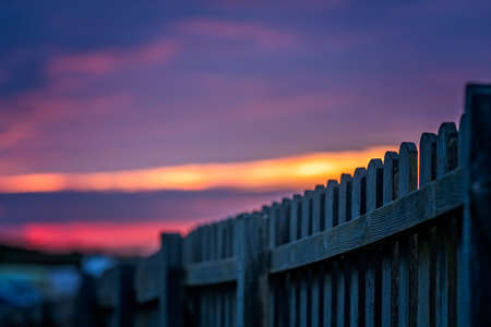 Wooden fence and the beautiful sky at sunset over the Cornish coast, St. Ives, Cornwall, Englandの写真素材