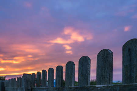 Wooden fence and the beautiful sky at sunset over the Cornish coast, St. Ives, Cornwall, Englandの写真素材