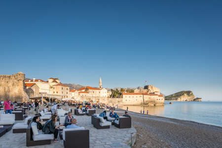 Budva, Montenegro - April 2018 : Crowd of tourists relaxing in beach seaside cafes and restaurants on the Adriatic coast in spring, Budva, Montenegroのeditorial素材