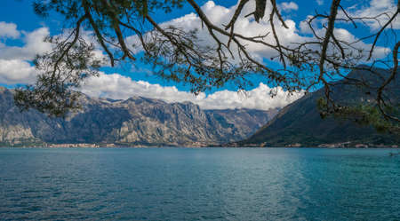 Stunning panoramic landscape of the sea and mountains in the Bay of Kotor as seen from the shore in Perast town, Montenegroの写真素材