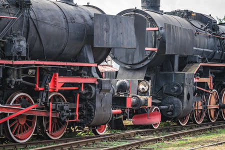 An old disused retro steam black train locomotives on the side trackのeditorial素材