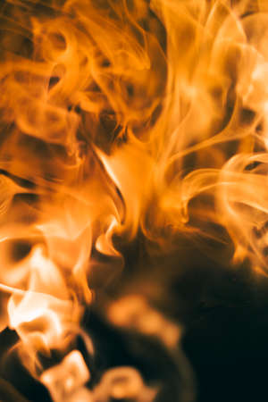 Shot of fire flames and glowing ashes on black background