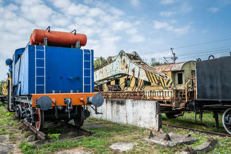 An old disused retro train cars and wagons on the side track in a museumのeditorial素材