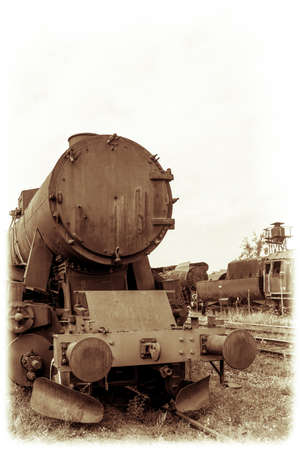 Retro vintage sepia photograph of an old disused retro steam train locomotive on the side trackのeditorial素材