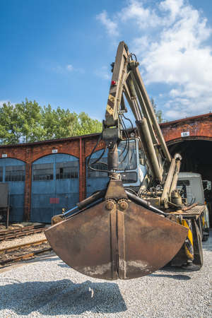 Large industrial excavator car used to unloading goods and material delivered by cargo trains in the depotのeditorial素材