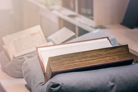 Large ancient books with old yellow pages close-up, picture taken in a museum libraryのeditorial素材