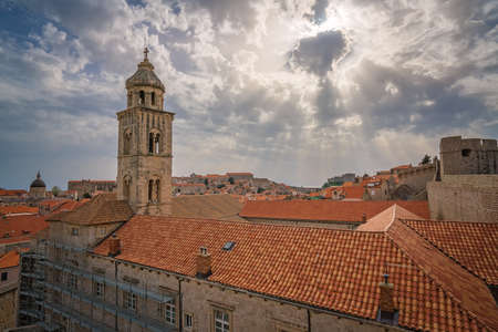 Church bell tower and rooftop of an old house in Dubrovnik, viewed from the Old Town fortified walls, Croatiaの写真素材