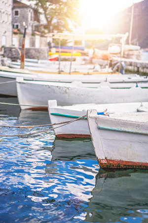 Anchored fishing boats on the shore in the beautiful Perast town in the Kotor Bay, Montenegro