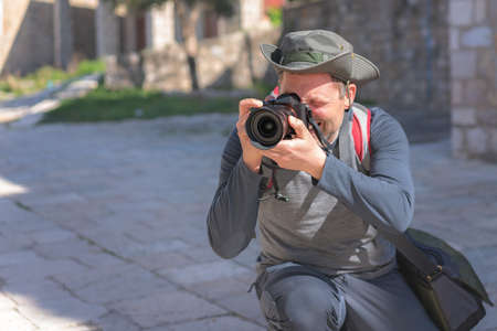 Portrait of a professional street and travel photographer with a camera pointed toward the subjectの写真素材