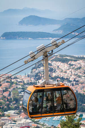 Dubrovnik, Croatia - April 2018 : Dubrovnik cable car, a popular tourist attraction taking people on the top of a Mount Srd above the historical Old Town Wallsのeditorial素材